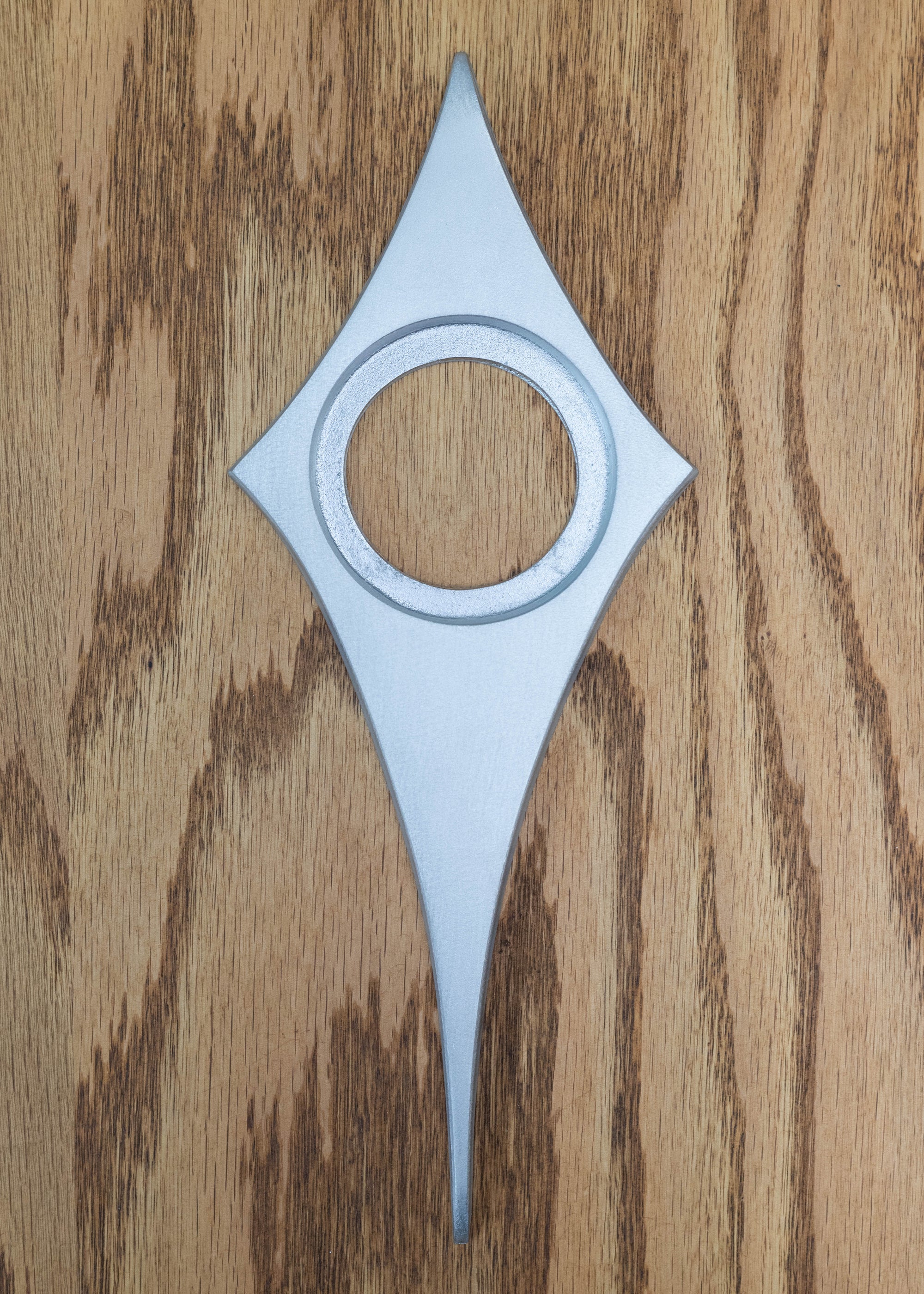 Bare aluminum comet escutcheon. There is no powder coating, so you can paint it whatever color you would like. The bare aluminum is brushed smooth and is a bright silver.
