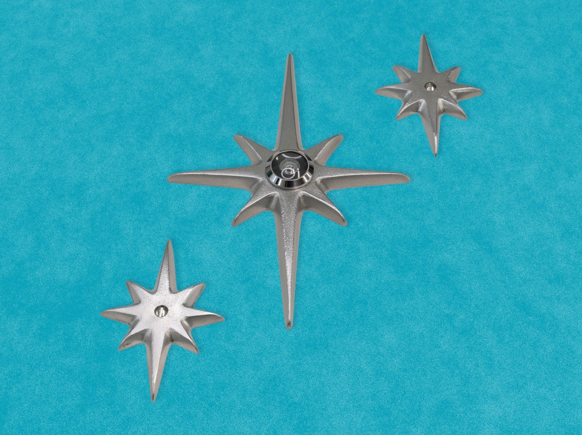 Angled photo of the set of three with peephole. You can clearly see the surface texture of the aluminum. The points and edges aer nicely smoothed and rounded. There is light reflection off the metal.