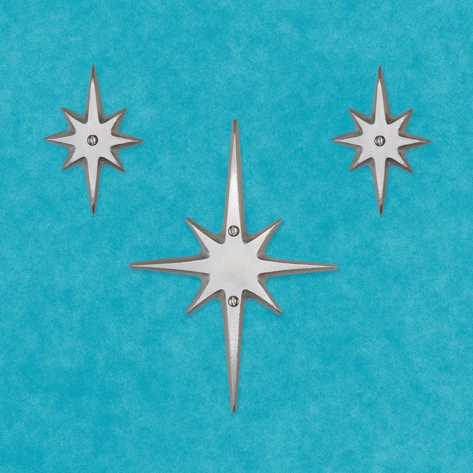 Another arrangement of the set of three without a peephole. The medium starburst is in the center. The two small starbursts are on the upper left and right.