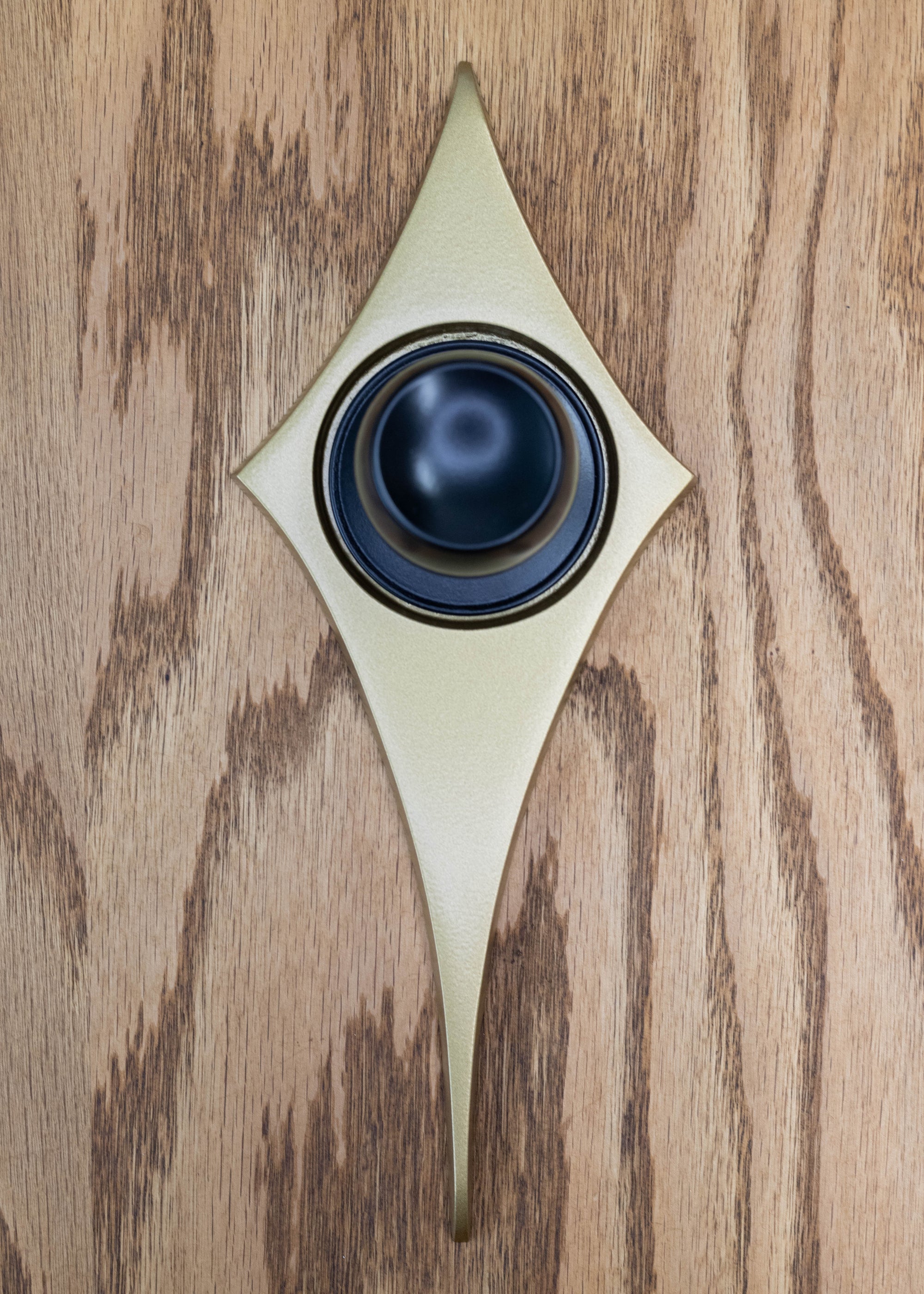 Gold comet pictured with a black doorknob. The black and gold contrast nicely!