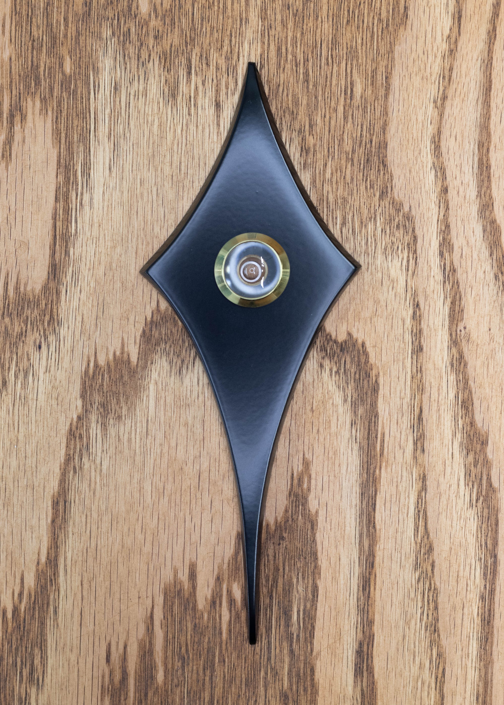 Matte black coating with a gold rimmed peephole viewer in the center.