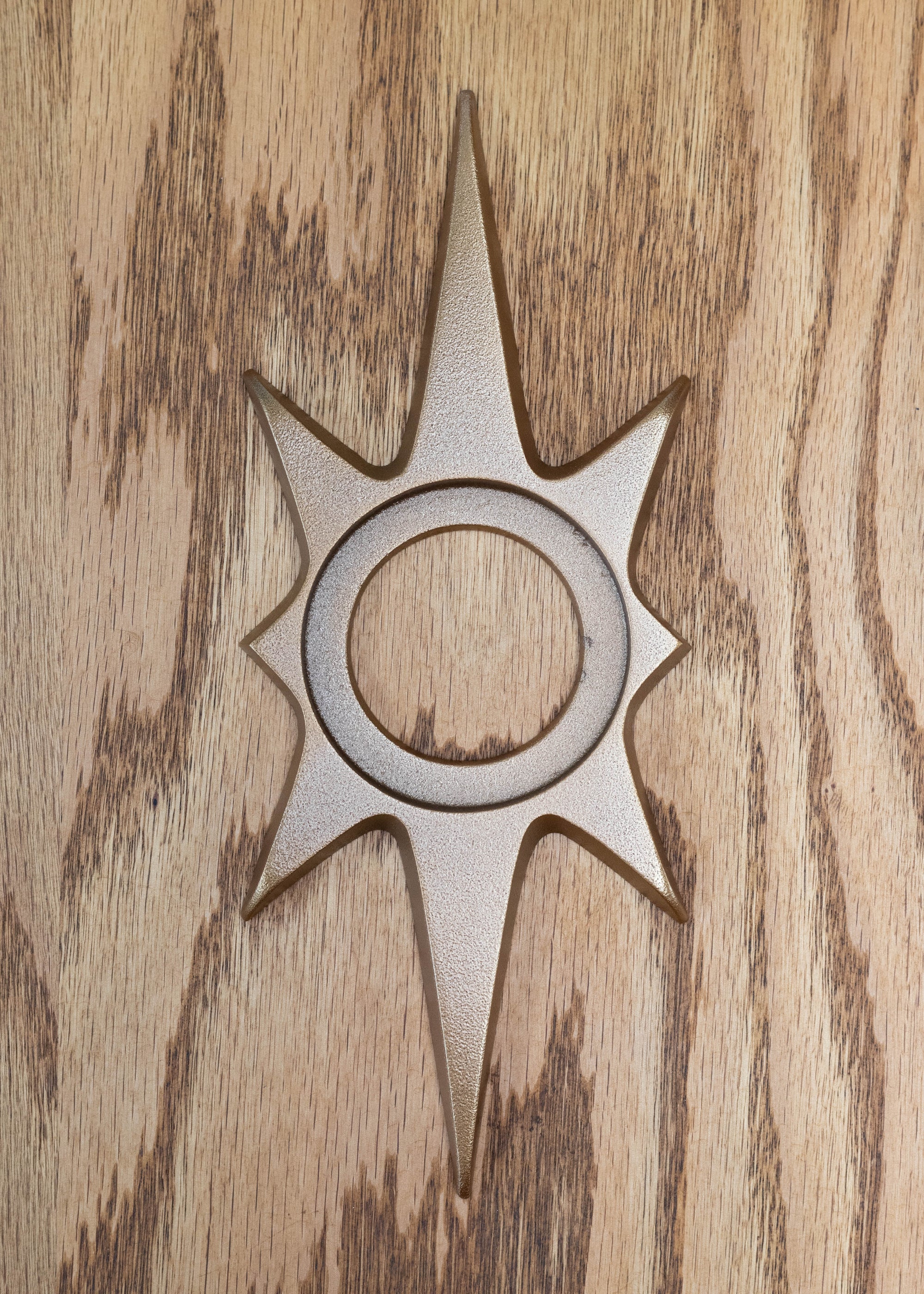The antique bronze starburst escutcheon. The antique bronze powder coating provides a smooth but more natural metallic finish that has shine but is not glossy like a polish. 