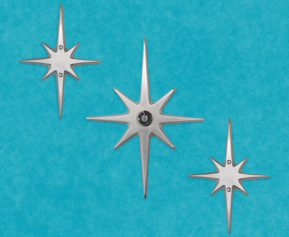 Large three-piece Atomic Starburst door decoration with a 10½-inch aluminum center star and two matching 7½-inch stars.