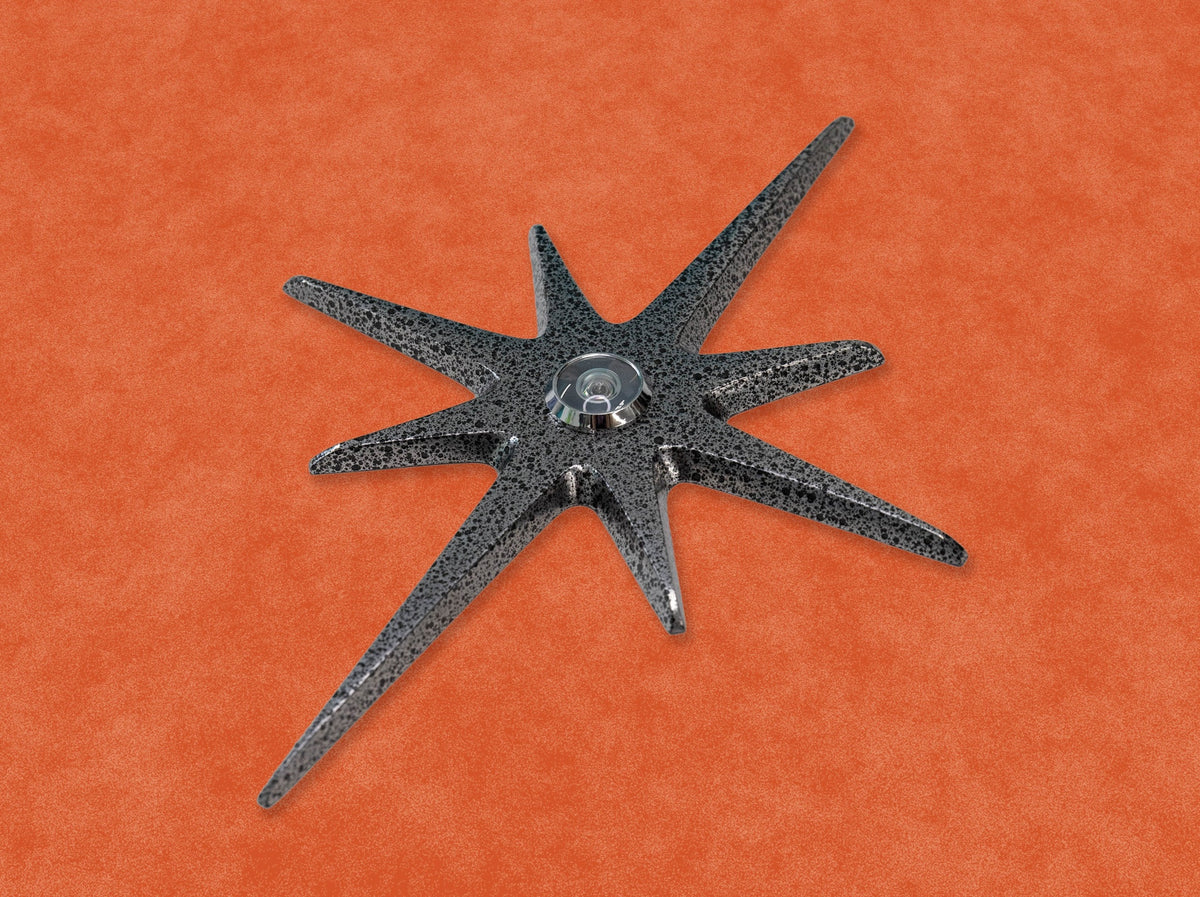 A closer angled look at the Black Frost starburst peephole. The metallic finish appears a darker silver at this angle.