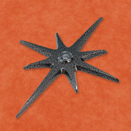 A closer angled look at the Black Frost starburst peephole. The metallic finish appears a darker silver at this angle.