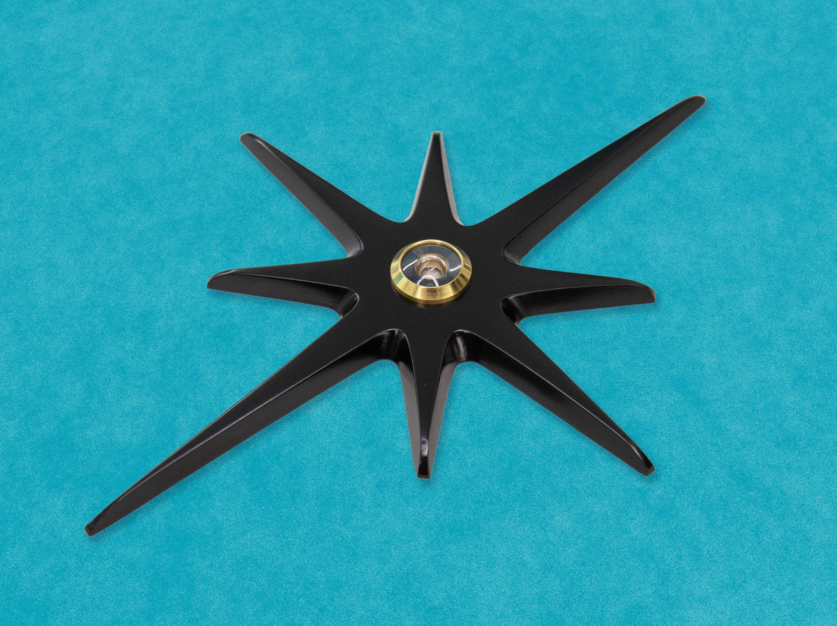 A closer angled look at the matte black starburst with a gold peephole viewer.