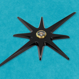 A closer angled look at the matte black starburst with a gold peephole viewer.