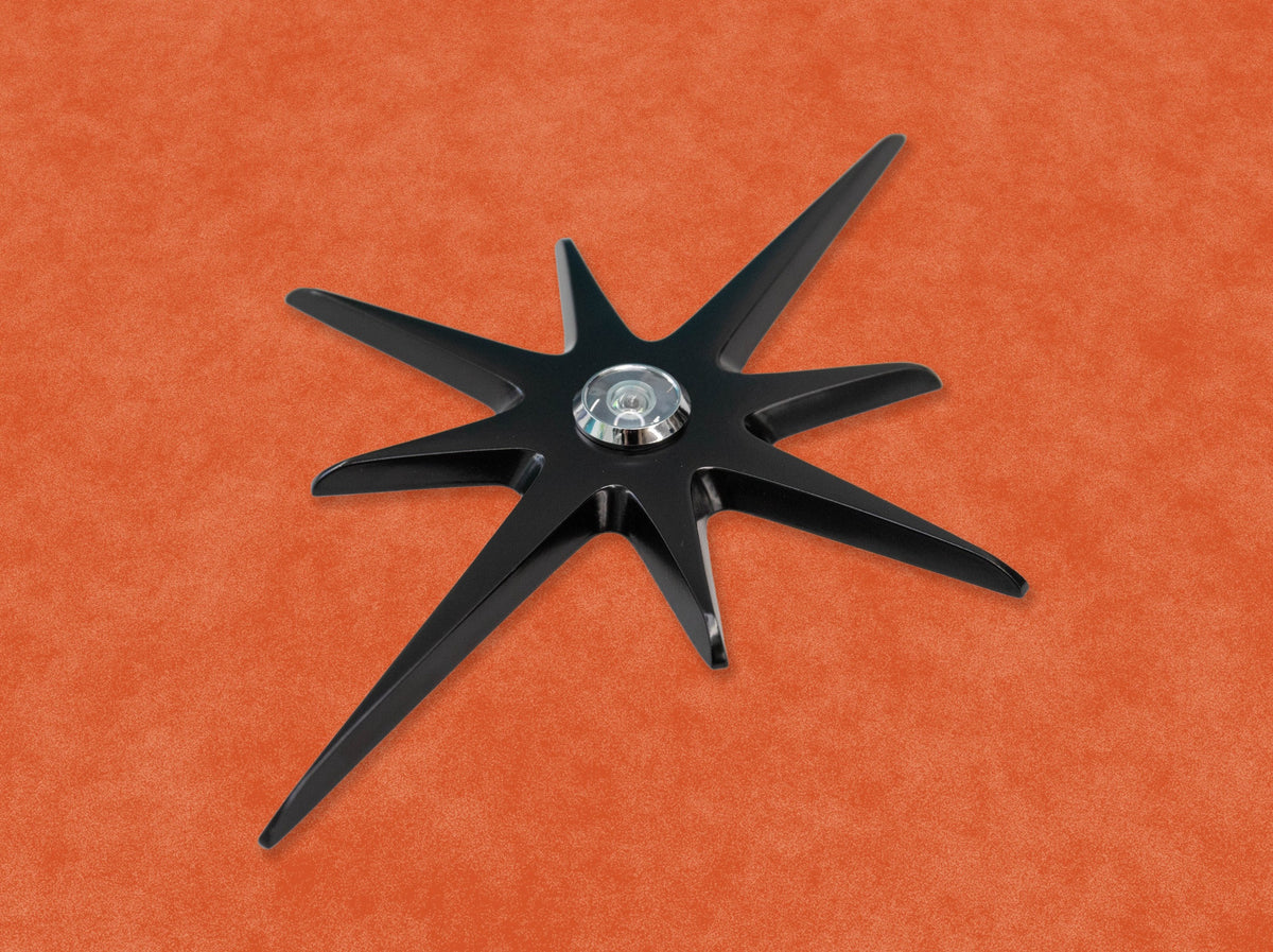 A closer, angled view of the black starburst with a silver peephole.
