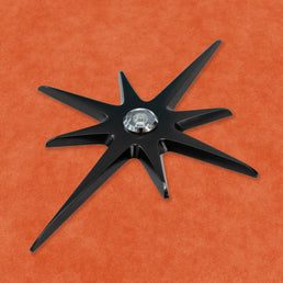 A closer, angled view of the black starburst with a silver peephole.