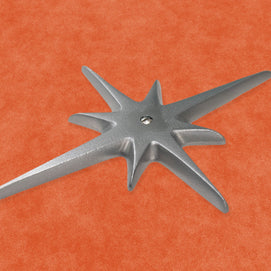 A closer view of the medium starburst with a single screw at its center. You can clearly see the slightly porous texture on the surface, but it still has a very nice smooth silver shine. The edges of the starburst points are nicely rounded off.