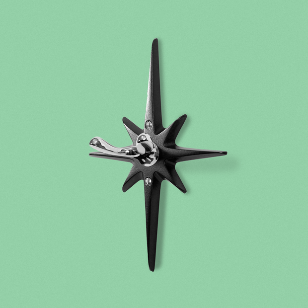 Midnight Star Robe hook featuring matte black cast aluminum starburst and contrasting chrome wall hook