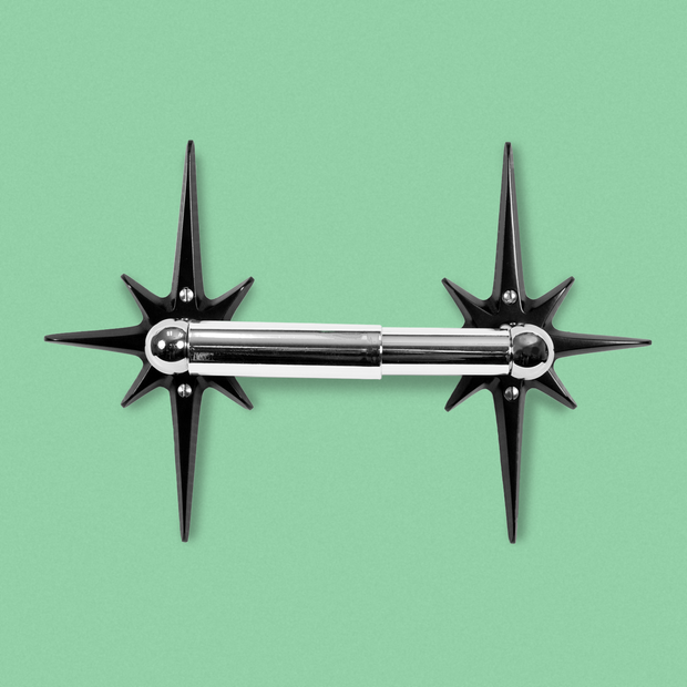 Midnight Star Toilet Paper Holder with two matte black aluminum starbursts and chrome-finished toilet paper rod.