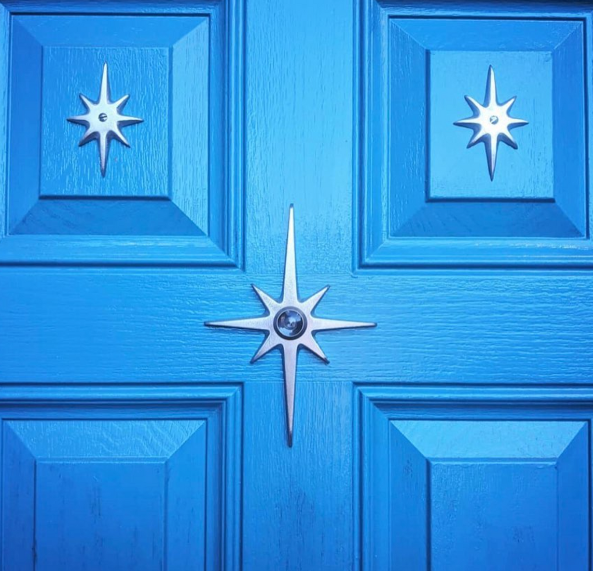 Atomic Starburst Peephole Viewer installed on a vintage-inspired front door.