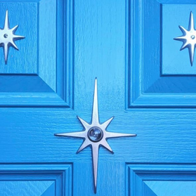 Atomic Starburst Peephole Viewer installed on a vintage-inspired front door.