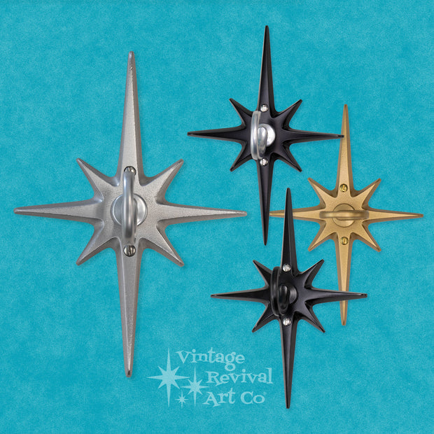 Four star-shaped wall hooks in silver, black, and gold on a blue background with 'Vintage Revival Art Co' branding.