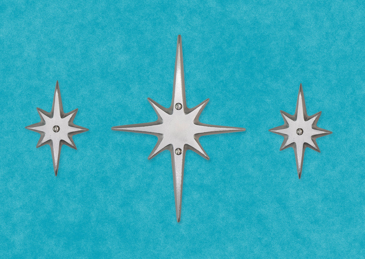 The set of three without the peephole viewer. The center medium starburst has two screws in top and bottom of the center area. Two small starbursts are on either side, each with a single screw in their center. 
