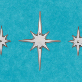 The set of three without the peephole viewer. The center medium starburst has two screws in top and bottom of the center area. Two small starbursts are on either side, each with a single screw in their center. 