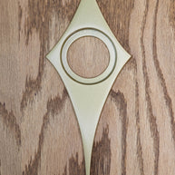 Gold powder coated comet door knob escutcheon. The finish is metallic with a bit of gloss and shine, so the texture is very smooth.