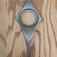 Gold vein powder coated comet escutcheon.  The gold vein is a pitted/ crackled texture that is a mixture of black and gold. It is still smooth and has a glossy finish that reflects light.