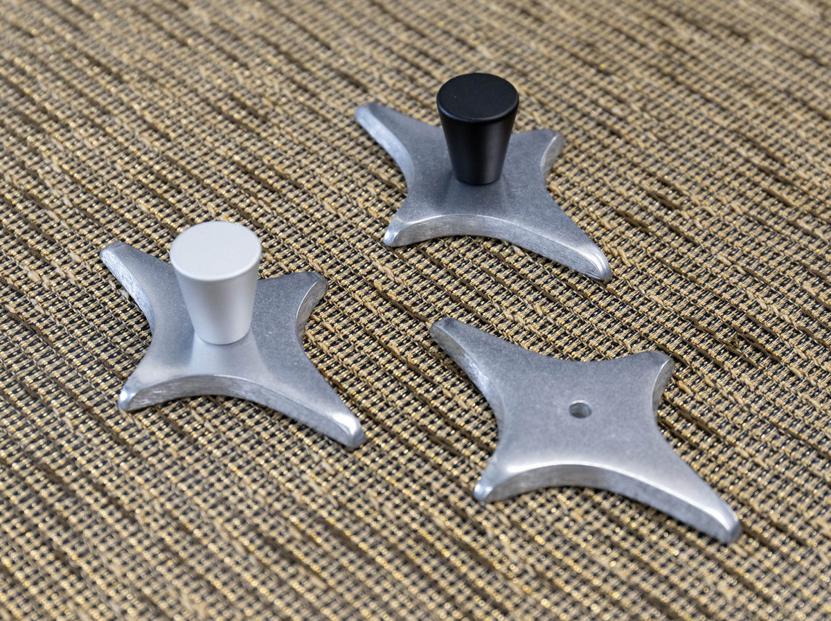 Diamond Star Drawer Pull and polished aluminum backing plate with a matte black cabinet knob.
