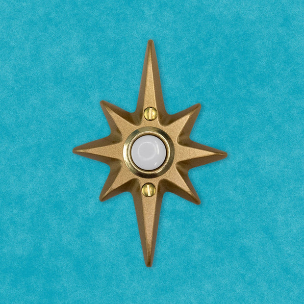 Gold Atomic Starburst Doorbell Button on a vintage-inspired front door.
