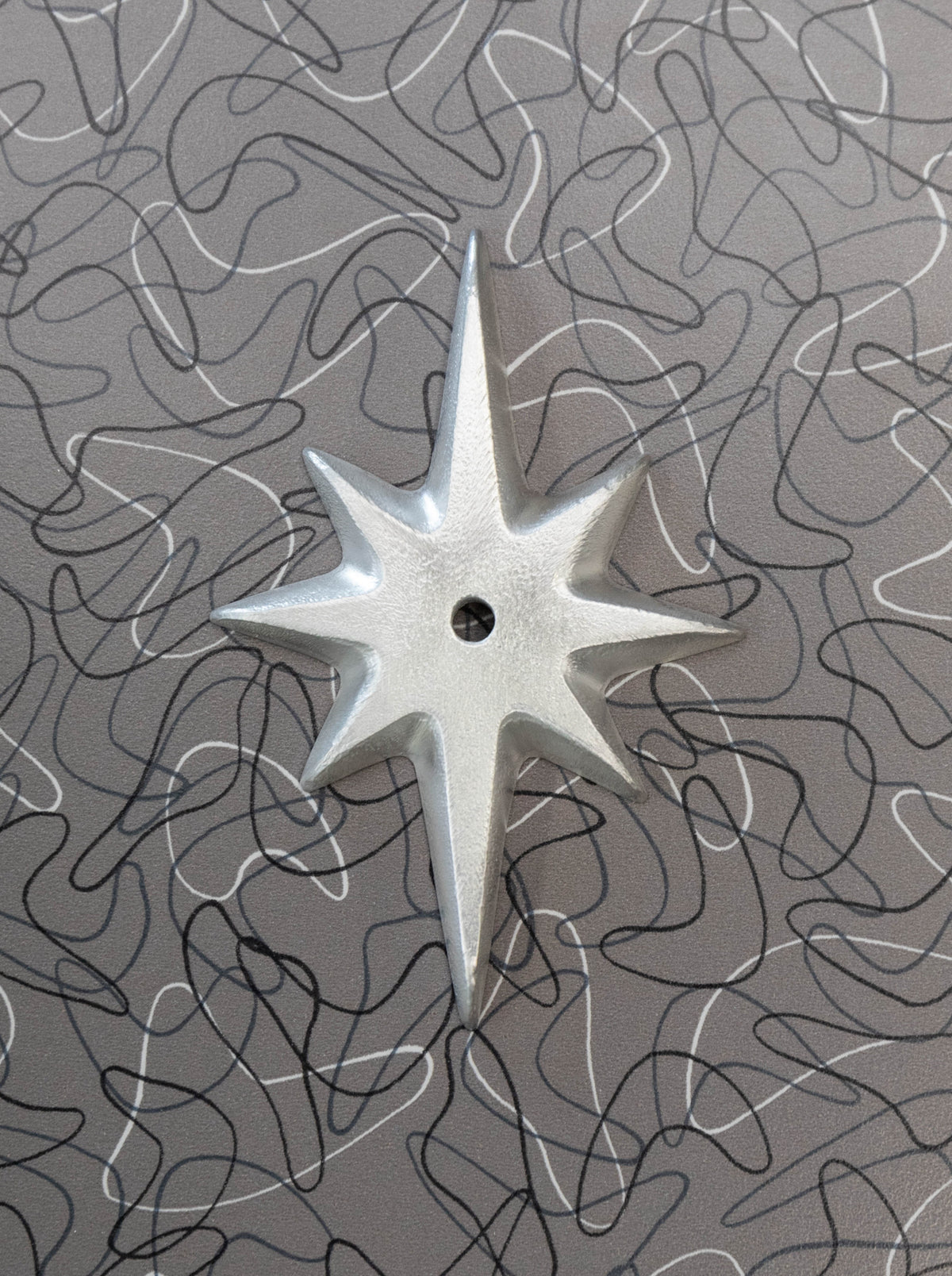 Pre-drilled Atomic Starburst Drawer Pull Backing Plate in shiny hammered cast aluminum without a knob.