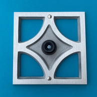 Handcrafted Breeze Block doorstop in cast aluminum with brushed finish, geometric design, and soft rubber wall-protecting stopper.