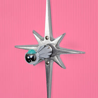 Closer view of the starburst purse/ coat hanger. The base that attaches to the wall is a cast aluminum starburst that is silver in color. Has naturally slightly porous surface texture, but is still very smooth and has a metallic shine to it. The hook part is chrome, and has a ball at the end that holds a marble.